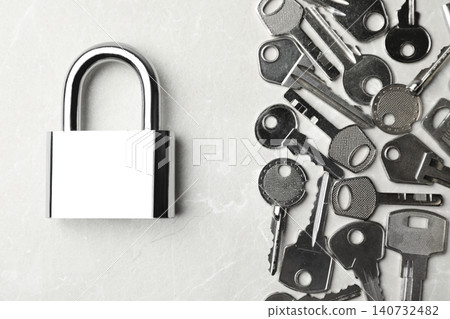 Steel padlock and keys on marble background, flat lay. Safety concept Steel padlock and keys on marble background, flat lay. Safety concept 140732482