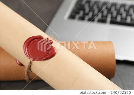Document with notary's wax stamp on grey table, closeup Document with notary's wax stamp on grey table, closeup 140732590