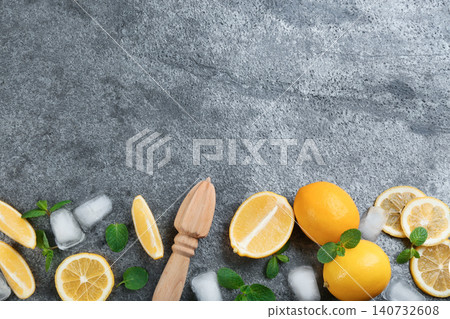 Lemonade layout with juicy lemon slices, mint and ice cubes on grey table, top view. Space for text Lemonade layout with juicy lemon slices, mint and ice cubes on grey table, top view. Space for text 140732608