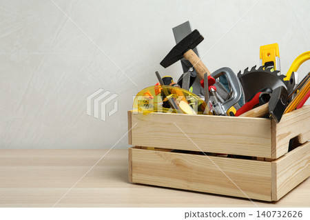 Crate with different carpenter's tools on wooden table. Space for text Crate with different carpenter's tools on wooden table. Space for text 140732626