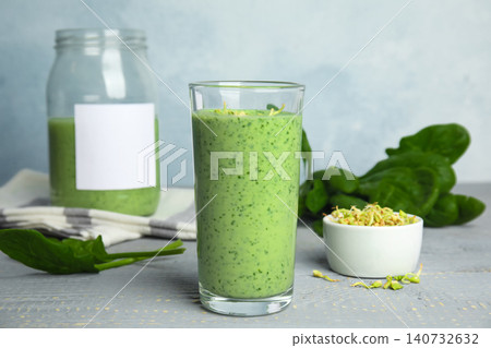 Green buckwheat smoothie on light grey wooden table Green buckwheat smoothie on light grey wooden table 140732632