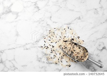 Mix of brown and polished rice with scoop on marble table, top view. Space for text Mix of brown and polished rice with scoop on marble table, top view. Space for text 140732645