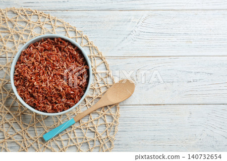 Delicious brown rice served on white wooden table, flat lay. Space for text Delicious brown rice served on white wooden table, flat lay. Space for text 140732654