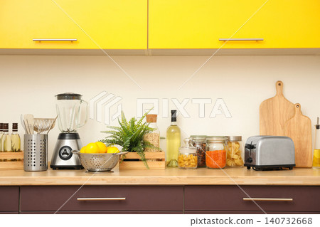 Stylish kitchen interior with wooden countertop and wall cabinets Stylish kitchen interior with wooden countertop and wall cabinets 140732668