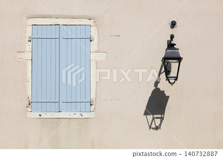 Closed window with blue shutters for the heat in the village of Montceaux in France Closed window with blue shutters for the heat in the village of Montceaux in France 140732887