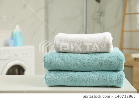 Stack of clean towels on table in laundry room 140732965