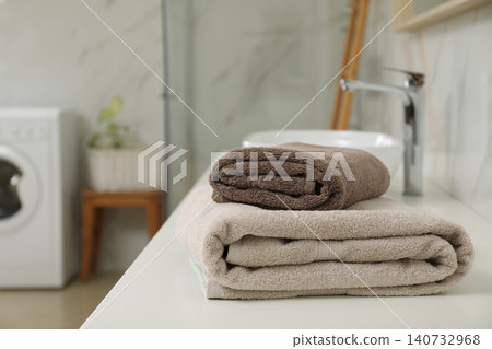 Stack of clean towels on bathroom countertop Stack of clean towels on bathroom countertop 140732968