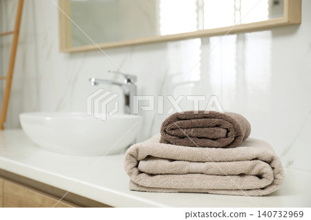 Stack of clean towels on bathroom countertop. Space for text Stack of clean towels on bathroom countertop. Space for text 140732969