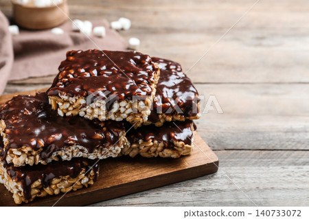 Delicious rice crispy treats on wooden table, closeup Delicious rice crispy treats on wooden table, closeup 140733072