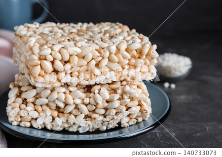 Delicious rice crispy treats on grey table, closeup Delicious rice crispy treats on grey table, closeup 140733073