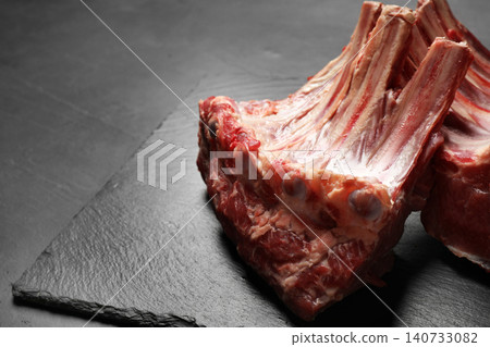 Raw ribs on slate board, closeup. Fresh meat Raw ribs on slate board, closeup. Fresh meat 140733082