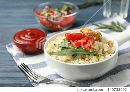 Delicious chicken risotto served in bowl on table Delicious chicken risotto served in bowl on table 140733092