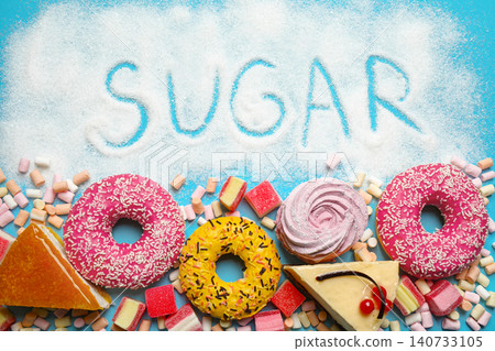Flat lay composition with sweets and word SUGAR on light blue background 140733105