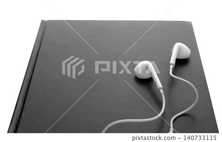 Bible and earphones on white background, closeup. Religious audiobook 140733115