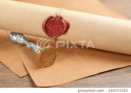 Notary's public pen and document with wax stamp on wooden table, closeup Notary's public pen and document with wax stamp on wooden table, closeup 140733163