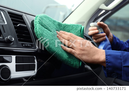Car wash worker cleaning automobile interior, closeup Car wash worker cleaning automobile interior, closeup 140733171