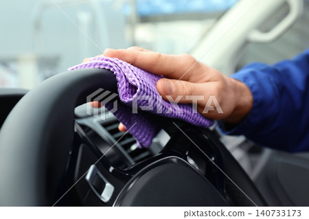 Car wash worker cleaning automobile interior, closeup Car wash worker cleaning automobile interior, closeup 140733173