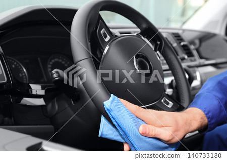 Car wash worker cleaning automobile interior, closeup Car wash worker cleaning automobile interior, closeup 140733180