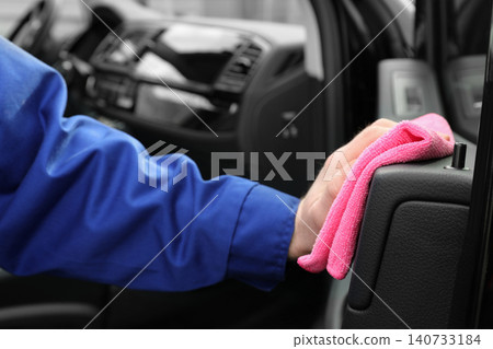 Car wash worker cleaning automobile interior, closeup Car wash worker cleaning automobile interior, closeup 140733184