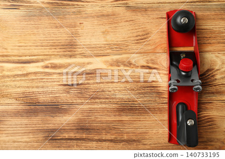 Modern jack plane and space for text on wooden background, top view. Carpenter's tool Modern jack plane and space for text on wooden background, top view. Carpenter's tool 140733195