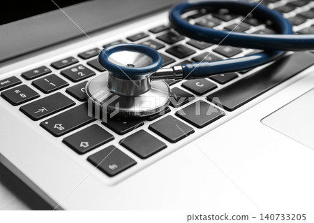 Laptop and stethoscope on table, closeup. Concept of technical support Laptop and stethoscope on table, closeup. Concept of technical support 140733205