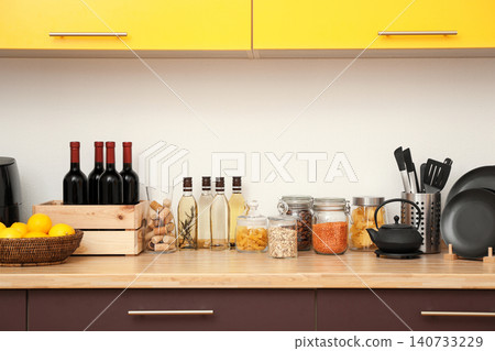 Stylish kitchen interior with wooden countertop and wall cabinets Stylish kitchen interior with wooden countertop and wall cabinets 140733229