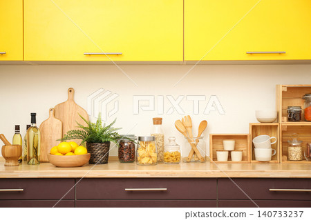 Stylish kitchen interior with wooden countertop and wall cabinets Stylish kitchen interior with wooden countertop and wall cabinets 140733237