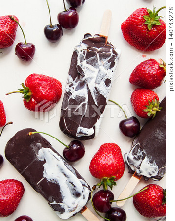 Sweet chocolate vanilla ice cream with red ripe strawberries and cherries, summer refreshing dessert Sweet chocolate vanilla ice cream with red ripe strawberries and cherries, summer refreshing dessert 140733278
