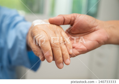 Caregiver holding hands Asian elderly woman patient, help and care in hospital. 140733333