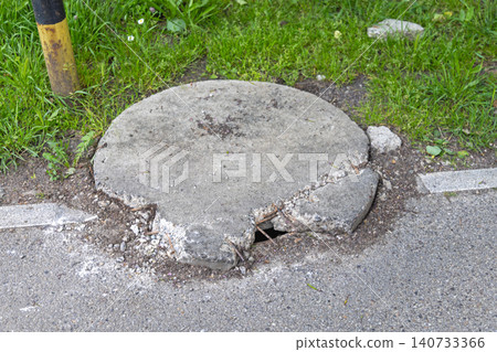 Damaged Concrete Manhole Cover Damaged Concrete Manhole Cover 140733366