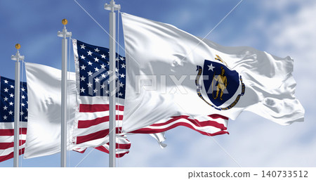 The flags of Massachusetts and the United States waving in the wind on a clear day 140733512