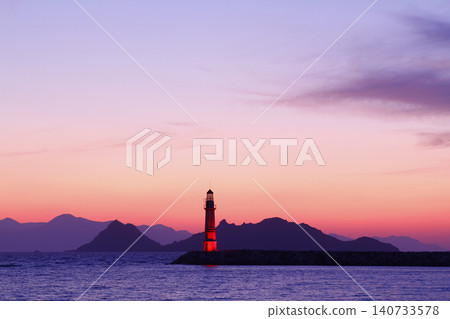 Seascape at sunshine. Lighthouse and sailings on the coast. Seaside town of Turgutreis and spectacular sunshine Seascape at sunshine. Lighthouse and sailings on the coast. Seaside town of Turgutreis and spectacular sunshine 140733578