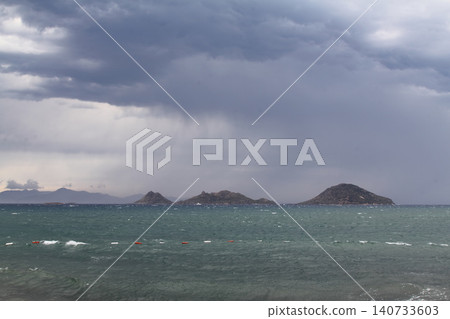 sunset on the beach. Seaside town of Turgutreis and spectacular sunsets. storm over the sea 140733603