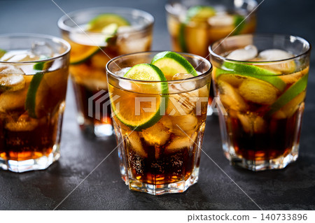 cocktail Cuba Libre with brown rum, cola and lime. Cuba Libre or long island cocktail. cocktail Cuba Libre with brown rum, cola and lime. Cuba Libre or long island cocktail. 140733896