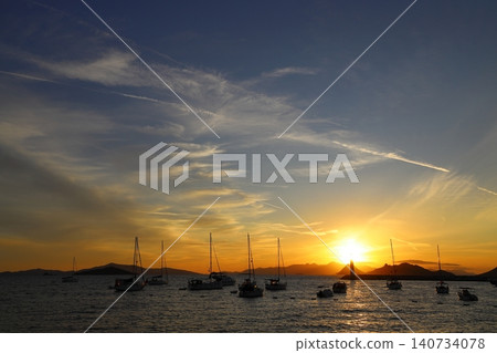 Seascape at sunshine. Lighthouse and sailings on the coast. Seaside town of Turgutreis and spectacular sunshine Seascape at sunshine. Lighthouse and sailings on the coast. Seaside town of Turgutreis and spectacular sunshine 140734078