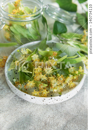 Linden flowers preparing for herbal tea infusion Linden flowers preparing for herbal tea infusion 140734110