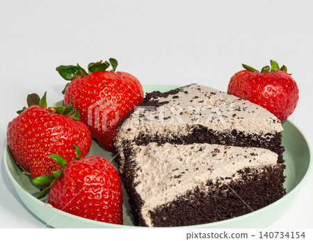 A slice of chocolate cake with forest berries and strawberries. A slice of chocolate cake with forest berries and strawberries. 140734154