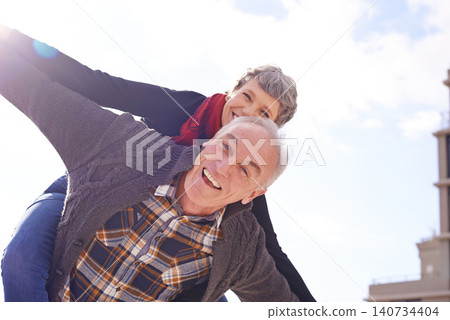 Portrait, happy couple and piggyback or love in vacation, retirement holiday and celebrate with smile. Outdoor, elderly people and marriage or commitment for bonding, care and romance in relationship Portrait, happy couple and piggyback or love in vacation, retirement holiday and celebrate with smile. Outdoor, elderly people and marriage or commitment for bonding, care and romance in relationship 140734404