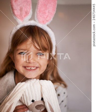 Girl, kid and bunny ears with teddy bear in portrait, soft toys and playing with smile and fun at family home. Happiness, innocent and child with stuffed animal, games for Easter and childhood Girl, kid and bunny ears with teddy bear in portrait, soft toys and playing with smile and fun at family home. Happiness, innocent and child with stuffed animal, games for Easter and childhood 140734445