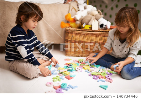 Children, friends and letter toys for learning, development and games in playroom at home. Young, boy and girl for education and growth in childhood with alphabet, language and kids playing for fun Children, friends and letter toys for learning, development and games in playroom at home. Young, boy and girl for education and growth in childhood with alphabet, language and kids playing for fun 140734446