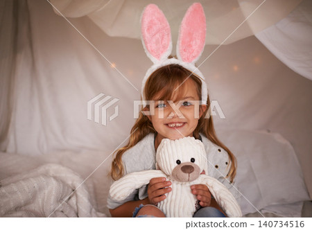 Girl, child and bunny ears with teddy bear, soft toys and playing in fort for camping and fun at family home. Happiness, innocent and kid with stuffed animal, games for Easter and joy in childhood Girl, child and bunny ears with teddy bear, soft toys and playing in fort for camping and fun at family home. Happiness, innocent and kid with stuffed animal, games for Easter and joy in childhood 140734516