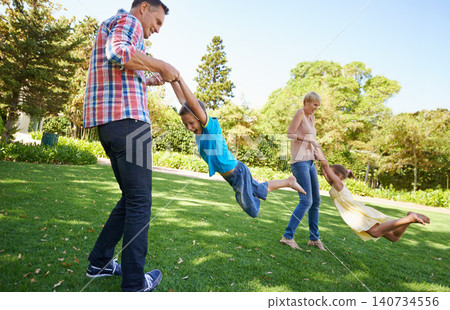 Parents, children and spinning fun in garden for bonding game together on park field for summer, recreation or connection. Mother, father and siblings with laugh on backyard grass, family or carefree Parents, children and spinning fun in garden for bonding game together on park field for summer, recreation or connection. Mother, father and siblings with laugh on backyard grass, family or carefree 140734556
