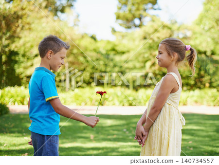 Boy, girl and flower present or outdoor connection with love kindness for young friendship, bonding or innocent. Children, smile and backyard garden for giving gift for summer holiday, play or park Boy, girl and flower present or outdoor connection with love kindness for young friendship, bonding or innocent. Children, smile and backyard garden for giving gift for summer holiday, play or park 140734557