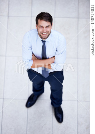 Business, portrait and high angle of man with arms crossed in office with confidence and pride. Above, entrepreneur and person in lobby to start morning in corporate London workplace with perspective Business, portrait and high angle of man with arms crossed in office with confidence and pride. Above, entrepreneur and person in lobby to start morning in corporate London workplace with perspective 140734832