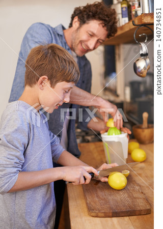 Father, child and fruit for lemonade in home for nutrition on kitchen counter for breakfast, beverage or diet. Male person, son and juicer tool in apartment or fresh citrus, vitamin c or gut health Father, child and fruit for lemonade in home for nutrition on kitchen counter for breakfast, beverage or diet. Male person, son and juicer tool in apartment or fresh citrus, vitamin c or gut health 140734851
