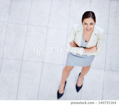High angle, portrait and happy woman with arms crossed in business or office with confidence and pride. Corporate, employee and above person in lobby excited for morning in workplace in London 140735164