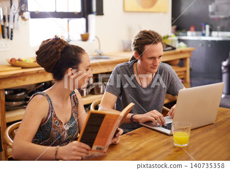 Laptop, home and couple relax in kitchen for online research, website and social networking. Marriage, love and man and woman on computer, reading books and bonding for relationship on weekend 140735358