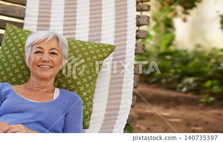 Senior woman and smile in garden with hammock to relax for retirement, break and enjoy. Portrait, female person and happy at home in summer or hot weather for outdoor and .satisfied with me time. Senior woman and smile in garden with hammock to relax for retirement, break and enjoy. Portrait, female person and happy at home in summer or hot weather for outdoor and .satisfied with me time. 140735397