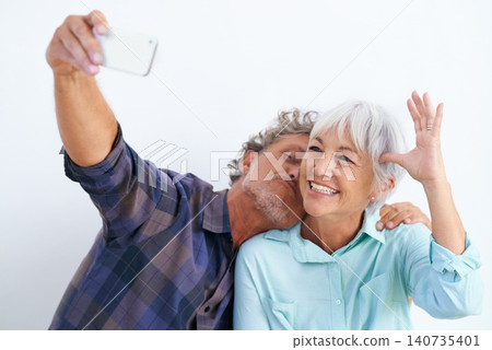 Old couple, kiss in selfie and happy together for social media post, memory and love with fun on white background. Affection, trust or loyalty with people in marriage, smile in picture and mobile app Old couple, kiss in selfie and happy together for social media post, memory and love with fun on white background. Affection, trust or loyalty with people in marriage, smile in picture and mobile app 140735401