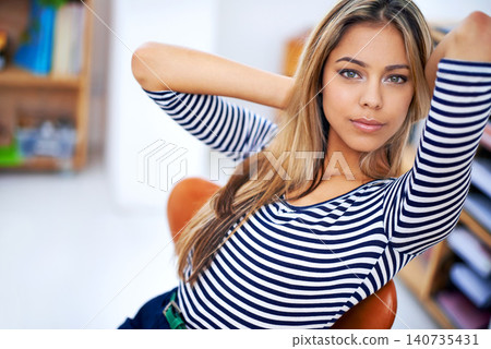 Confident, portrait of woman relaxing in office for complete creative company project deadline. Pride, career and female designer with hands by head with satisfaction for achievement in workplace. Confident, portrait of woman relaxing in office for complete creative company project deadline. Pride, career and female designer with hands by head with satisfaction for achievement in workplace. 140735431
